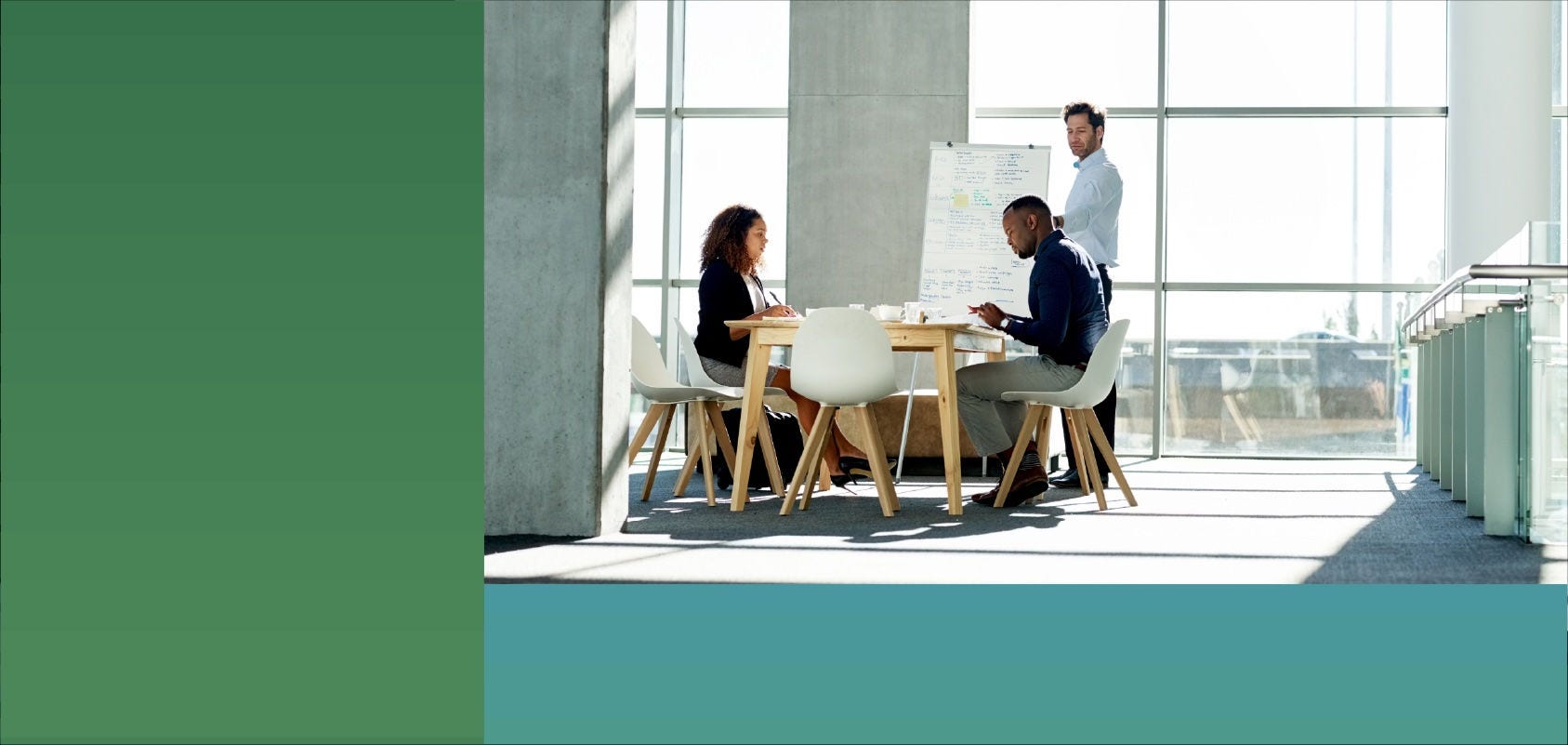 A small team discuss a project during a meeting in an open office environment.